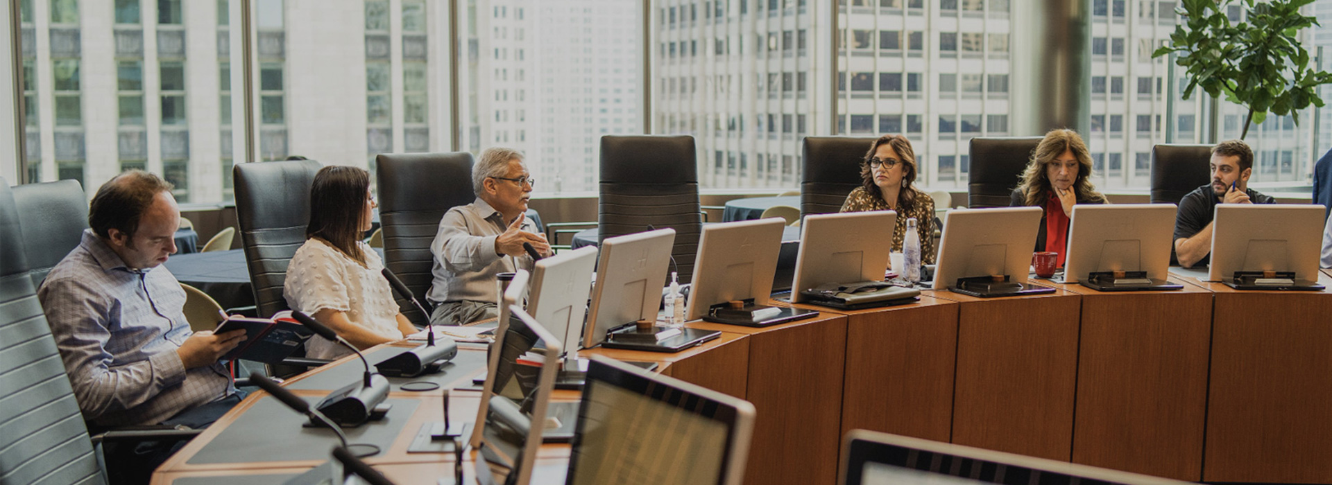 Several GNP Realty staff members have a meeting in a large boardroom